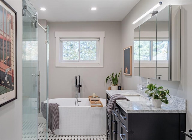 bathroom featuring vanity and plus walk in shower