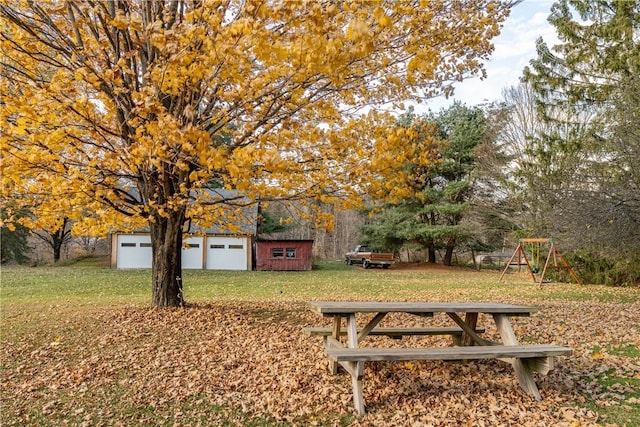 exterior space with a playground, a storage unit, and a lawn