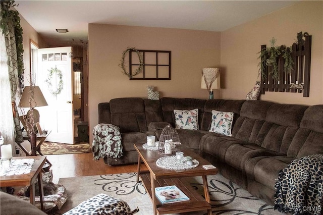 living room featuring visible vents and wood finished floors