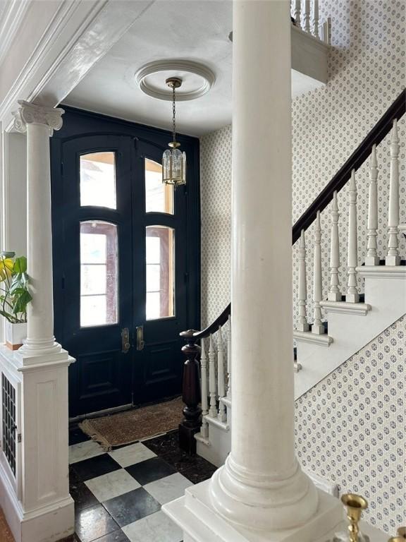 foyer entrance featuring french doors and a chandelier