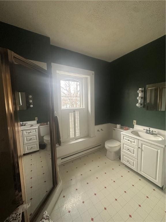 bathroom with vanity, a textured ceiling, and toilet