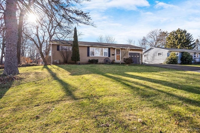 ranch-style home with a front yard and a garage