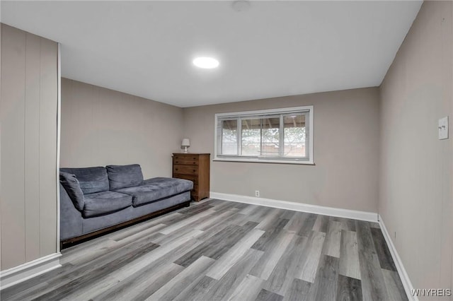 living area featuring baseboards and wood finished floors