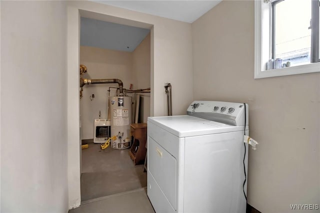 clothes washing area with laundry area, washer / clothes dryer, and water heater