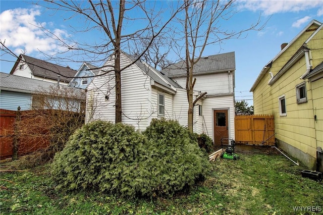 view of side of property featuring fence