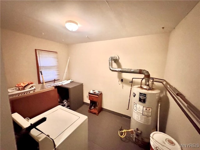 washroom featuring baseboards, laundry area, and water heater