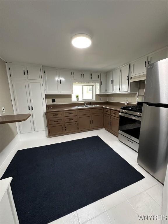 580 S Ogden St, Buffalo, NY 14206 - kitchen featuring appliances with stainless steel finishes, dark countertops, and light tile patterned floors