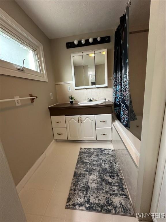 580 S Ogden St, Buffalo, NY 14206 - full bath with vanity, tiled shower / bath combo, decorative backsplash, and a textured ceiling