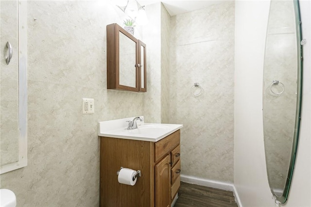 bathroom with hardwood / wood-style floors and vanity