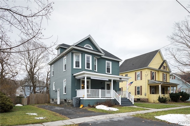 view of front of property with a porch and a front yard