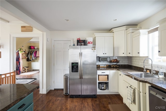 kitchen featuring white cabinets, appliances with stainless steel finishes, dark hardwood / wood-style floors, and sink