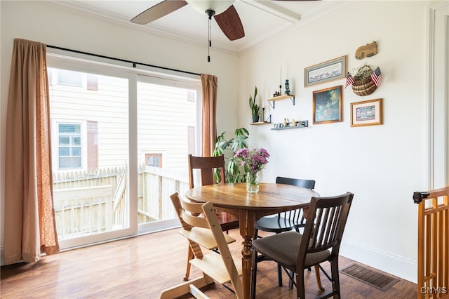 dining space featuring plenty of natural light, hardwood / wood-style floors, and ornamental molding