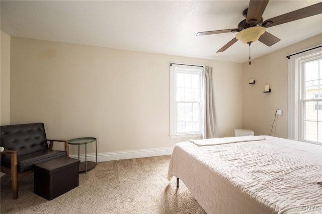 bedroom with carpet flooring, multiple windows, and ceiling fan