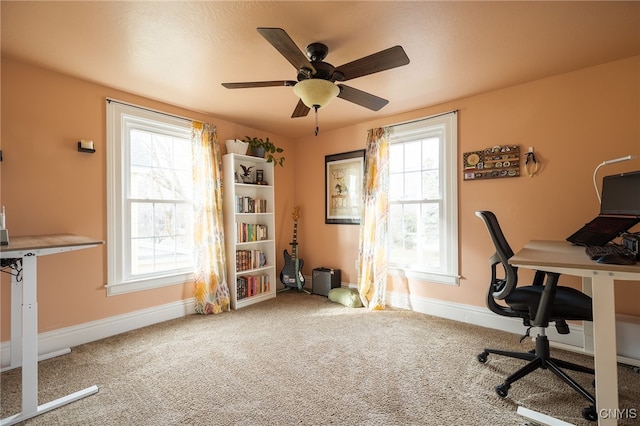 office area with a wealth of natural light, ceiling fan, and carpet