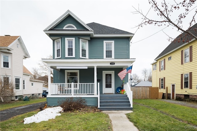 view of front of property featuring a porch and a front lawn