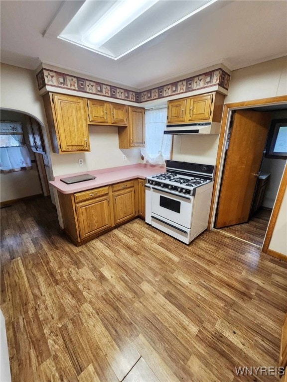 kitchen featuring white gas range and light hardwood / wood-style flooring