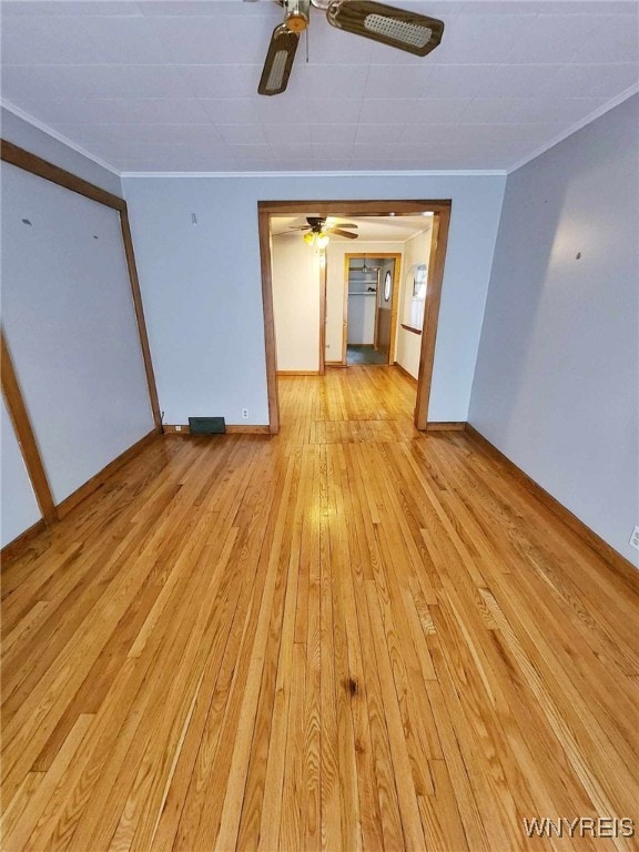 unfurnished living room featuring light hardwood / wood-style floors and ornamental molding