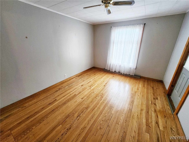 unfurnished room featuring ceiling fan, light hardwood / wood-style flooring, and ornamental molding