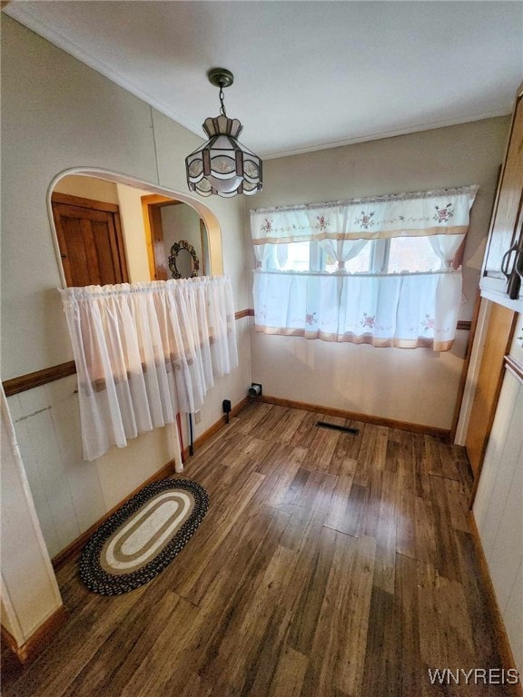 unfurnished dining area featuring dark hardwood / wood-style flooring