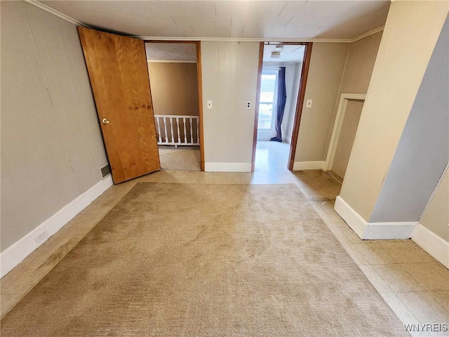 empty room featuring ornamental molding