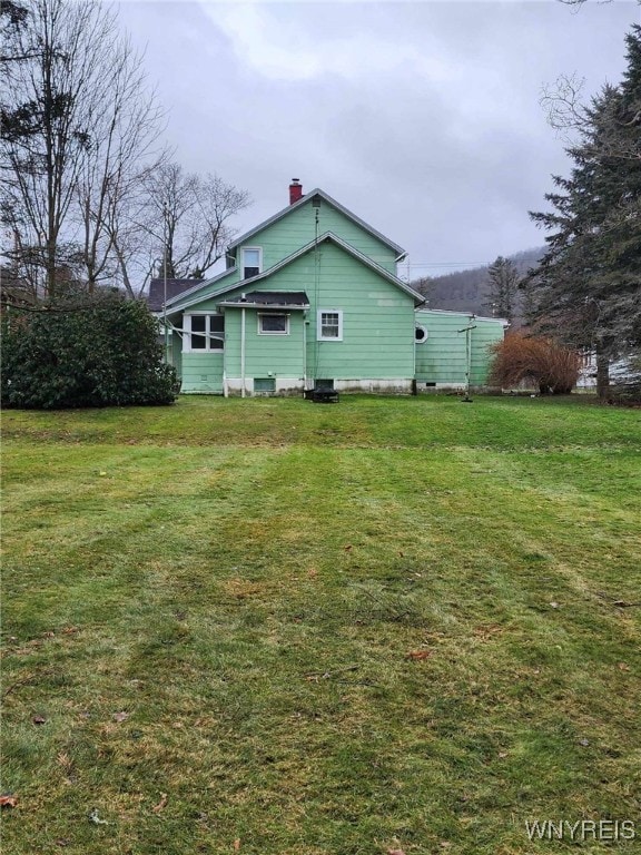 view of side of home featuring a yard