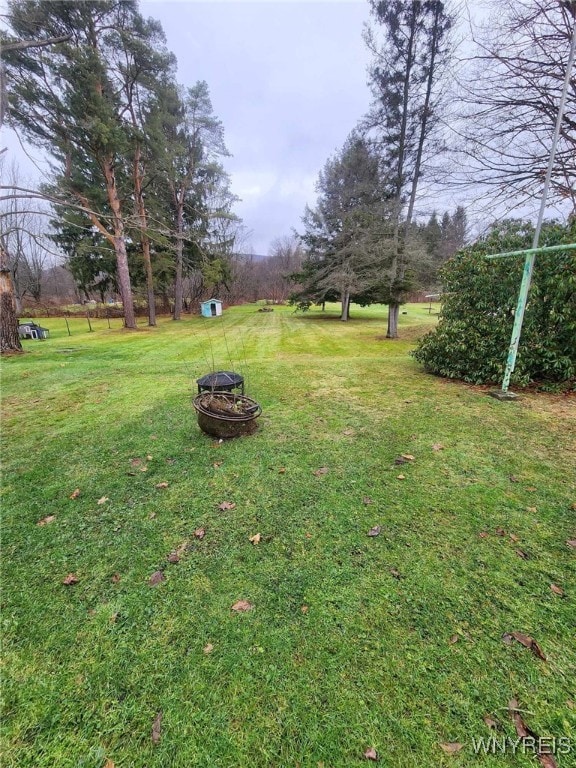 view of yard with an outdoor fire pit