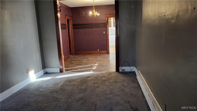 corridor featuring a chandelier, carpet floors, and baseboard heating