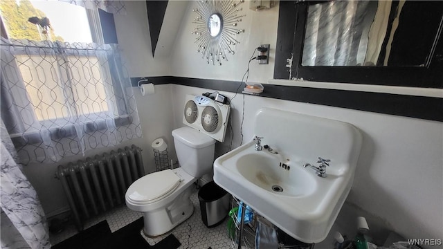 bathroom featuring toilet, radiator, and sink