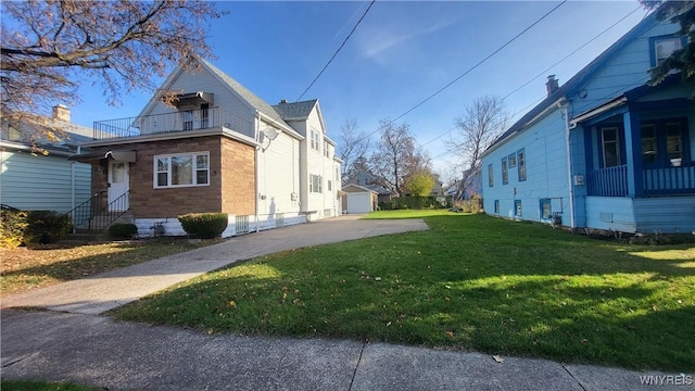 view of property exterior featuring a lawn, a garage, and an outdoor structure