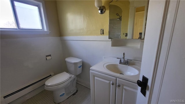 bathroom with tile patterned flooring, vanity, a baseboard radiator, and toilet