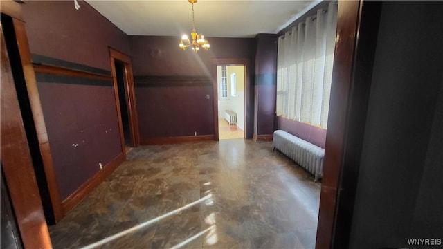 interior space featuring radiator and a chandelier