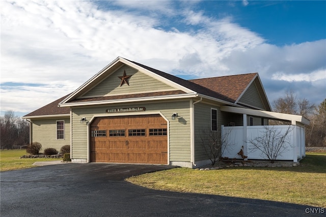 view of front of house with a garage and a front lawn