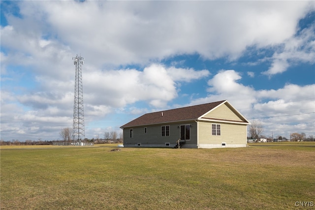 rear view of property featuring a lawn