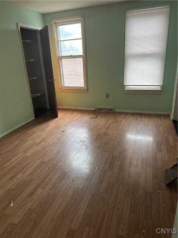 empty room with hardwood / wood-style flooring