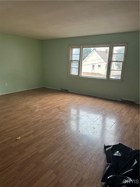 empty room featuring wood-type flooring