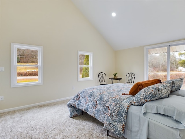 bedroom with carpet flooring and high vaulted ceiling