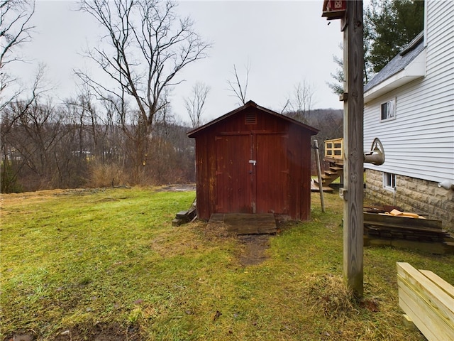 view of outbuilding featuring a lawn