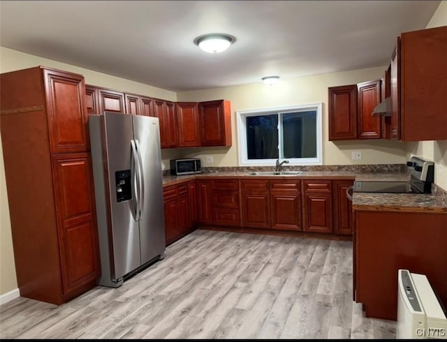 kitchen featuring light wood-type flooring, sink, and appliances with stainless steel finishes