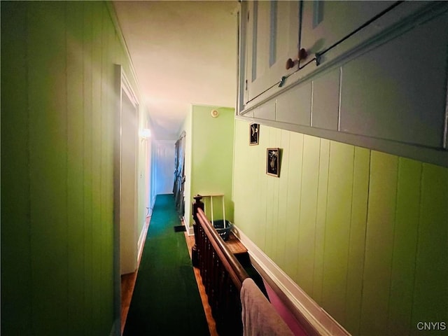 corridor featuring wood walls