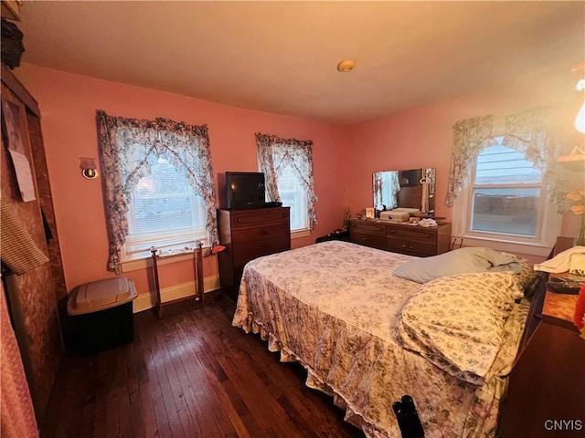 bedroom featuring dark wood-type flooring and multiple windows