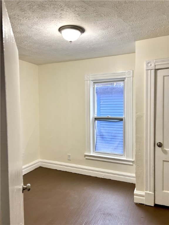 spare room with a textured ceiling and a healthy amount of sunlight