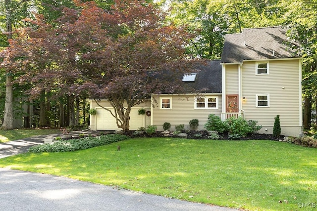 view of front of house with a garage and a front lawn