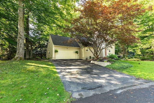 view of front of house with a front yard and a garage