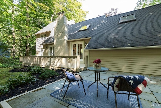 rear view of house with french doors, a deck, and a patio area