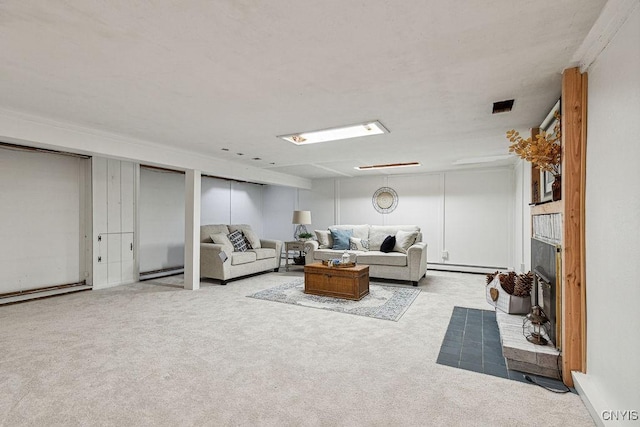 carpeted living room with a fireplace and a baseboard heating unit