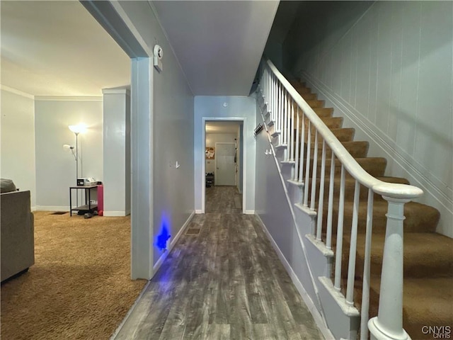 hallway featuring dark hardwood / wood-style floors and ornamental molding