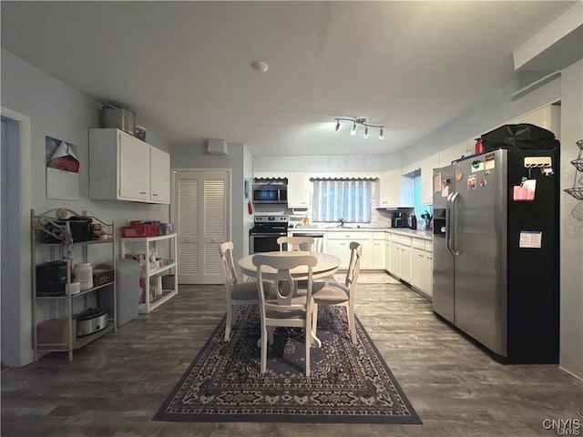 kitchen featuring sink, white cabinets, dark wood-type flooring, and appliances with stainless steel finishes