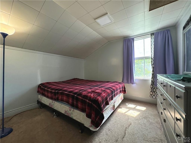 bedroom featuring light colored carpet and vaulted ceiling