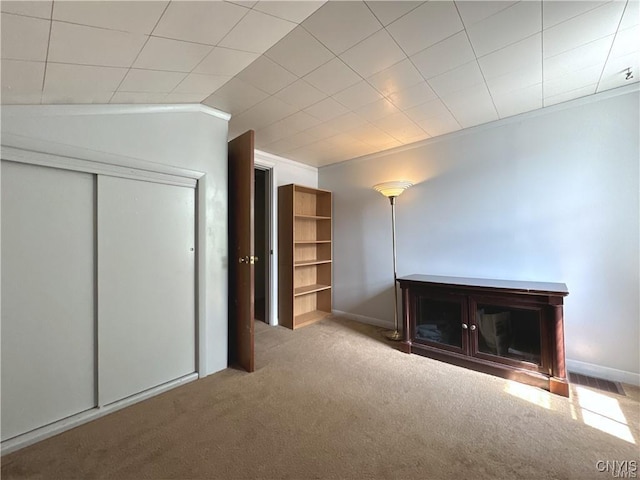 interior space featuring light colored carpet and vaulted ceiling