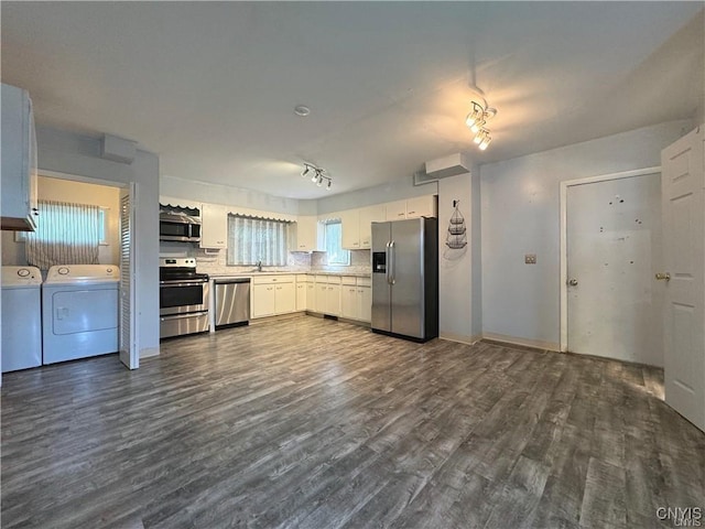 kitchen featuring dark hardwood / wood-style flooring, tasteful backsplash, stainless steel appliances, washing machine and dryer, and white cabinetry